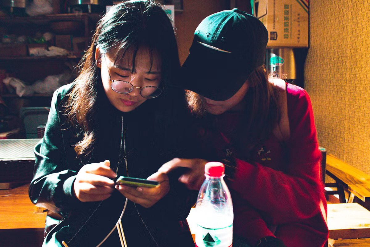 Two women looking at a smartphone together